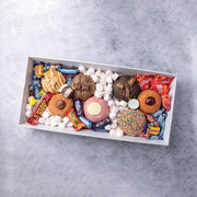 Office employees eating corporate doughnut gift box with donuts and lollies