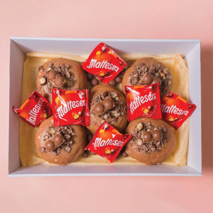 Young family eating Maltesers flavour doughnuts at birthday party in brisbane